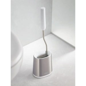 Joseph Joseph Flex Lite Steel Toilet Brush with white handle and stainless steel holder positioned on bathroom floor next to white toilet