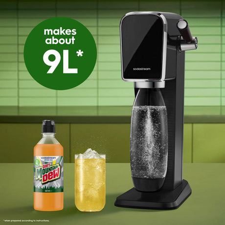 SodaStream black carbonated water maker with Diet Mountain Dew bottle and glass of fizzy yellow beverage on green tiled background, showing makes about 9L capacity