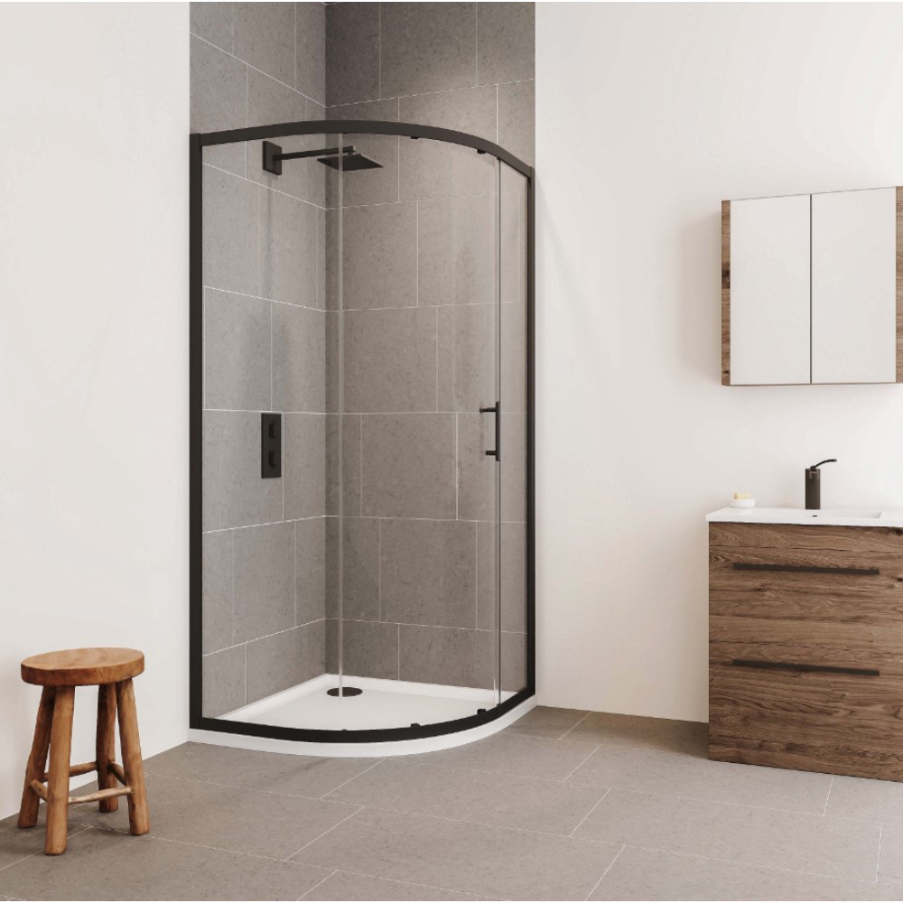 Modern bathroom featuring a black-framed curved glass shower enclosure with white tray, gray tile walls, wooden vanity with white basin and black tap, mirrored cabinet, wooden stool, and light tile flooring