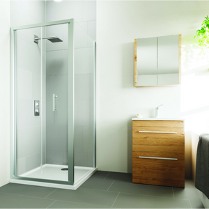 Flair VERVE PRO bifold shower door in chrome frame with frosted glass panel installed in modern bathroom with white tiles, wooden vanity unit, mirrored cabinet and dark floor tiles