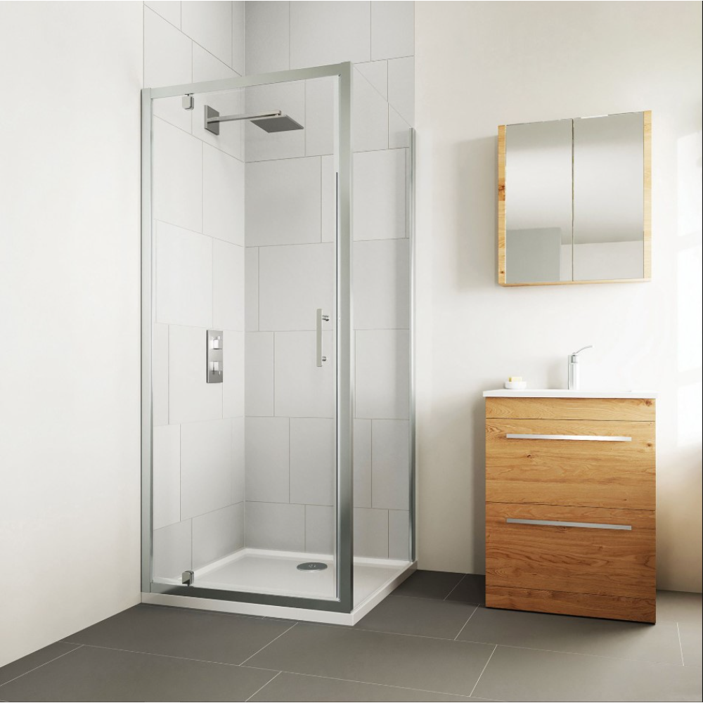 Flair Verve Pro Pivot Shower Door in chrome and black displayed in a modern bathroom with white subway tiles, wooden vanity unit, and grey floor tiles