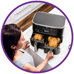 Woman using a multi-cooker with two pots on a kitchen counter
