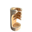 Hand-carved wooden wine bottle holder with natural light wood finish featuring a decorative hand design holding a bottle, rustic Celtic craftsmanship style