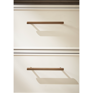 Modern minimalist vanity unit drawer details showing bronze ribbed handles on cream and white cabinetry with shadow effects