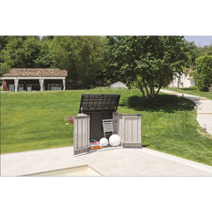 Toomax Storer Plus garden storage unit in taupe grey and anthracite with open lid displaying stored garden tools and equipment on a patio, surrounded by manicured lawn and trees