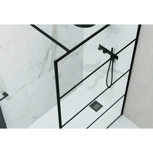 Modern marble wetroom with Flair AYO 8mm black framed glass shower panel, matte black showerhead and rail system, and integrated floor drain against veined white marble tiles