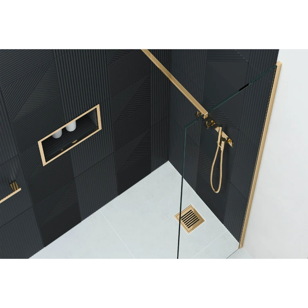 Modern luxury bathroom wetroom shower enclosure featuring Flair AYO 8mm glass panels with brushed brass frame, black textured wall tiles, white floor, integrated rainfall showerhead and handheld shower system, recessed shelf niche and floor drain