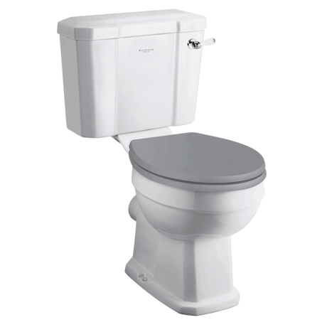 White ceramic close coupled toilet with grey soft-close seat and cistern with chrome flush handle, classic traditional design