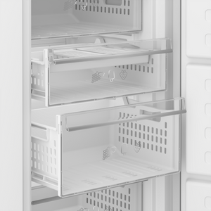 Interior view of a Blomberg integrated frost-free freezer showing multiple clear glass shelves and pull-out drawers with ventilation slots, featuring fruit and ice cream icons on drawer fronts, white trim and handles against a stainless steel finish
