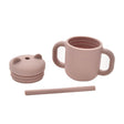 Pink children's cup with lid and straw on a white background