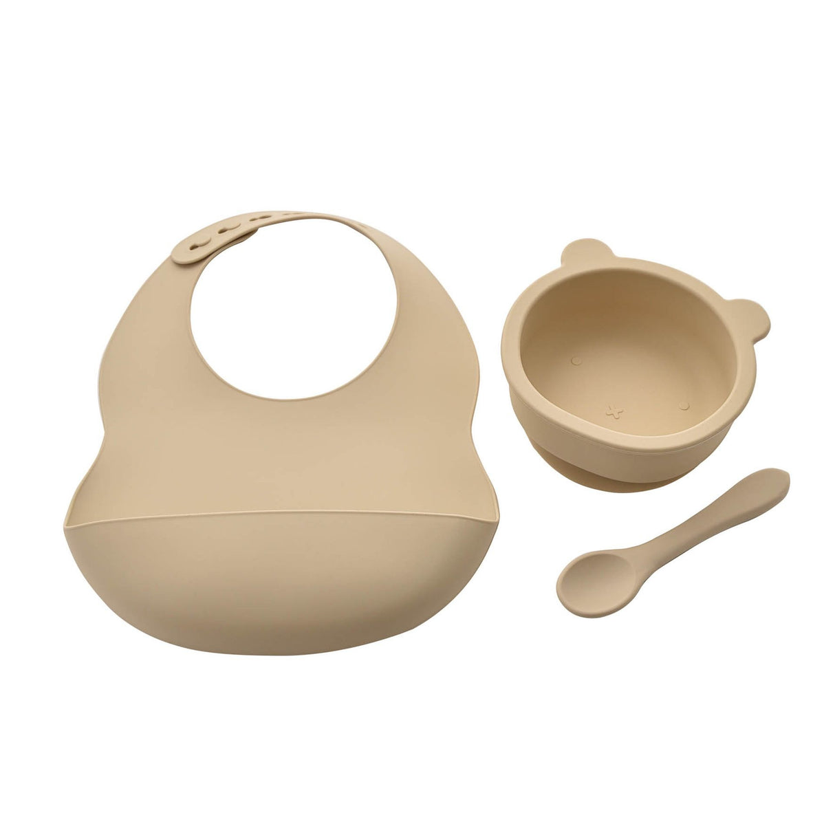 Beige silicone bib, bowl, and spoon set on a white background
