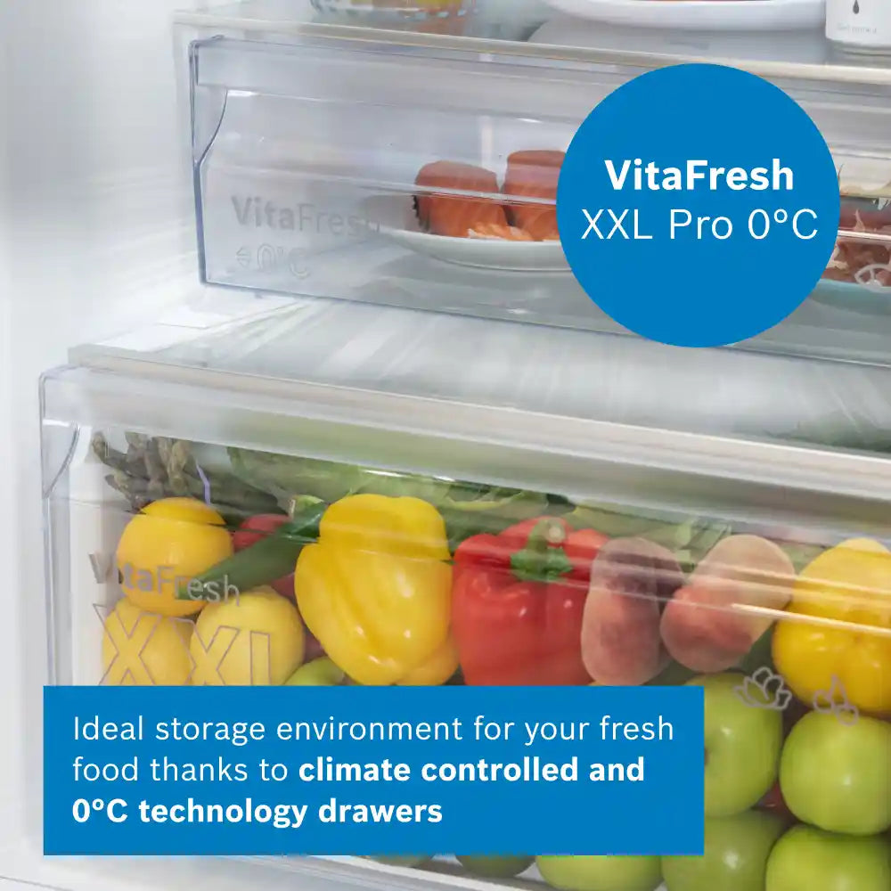 Bosch Series 4 KGN392WDFG white fridge freezer with VitaFresh XXL Pro 0°C climate controlled drawers containing fresh vegetables including yellow peppers, red peppers, and green apples, with eggs stored in upper drawer