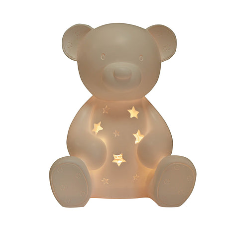 Cream-colored translucent silicone teddy bear night light with illuminated star cutouts on the chest, round ears, and textured paw pad details, sitting upright against a white background