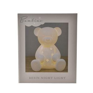 Bambino resin night light in the shape of a cream-colored teddy bear with star cutouts and glowing interior, displayed in branded packaging
