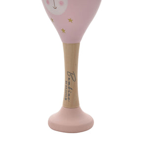 Bambino wooden maraca with pink cone-shaped head featuring a smiling face and gold stars, natural wood handle with branding, and pink base