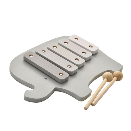 Wooden toy xylophone in the shape of an elephant with light gray body, five white wooden bars with metal resonators, and two natural wooden mallets with spherical heads