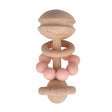 Wooden teething ring with pink beads on a white background