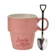 Pink mug with 'Lovely Mum' text and a metal shovel on a white background