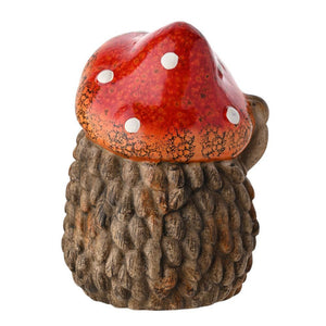 Decorative garden ornament featuring a ceramic hedgehog with textured brown quills wearing a red and white spotted toadstool mushroom hat with weathered finish