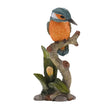 Decorative bird figurine perched on a branch with leaves on a white background