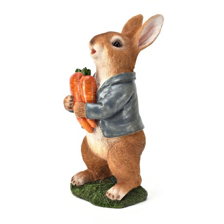 Decorative resin rabbit figurine wearing a gray jacket, holding a bunch of orange carrots, standing on green grass base, country cottage style garden ornament