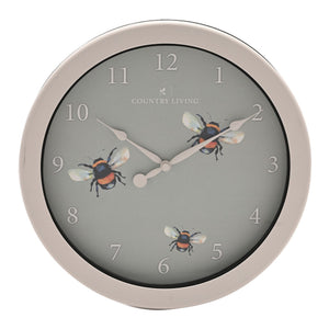 Wall clock with bee design on a gray background, brand 'Country Living' visible