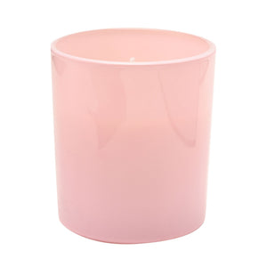 Pink cylindrical scented candle with white rim in a modern minimalist style, displayed against a white background