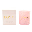 Pink candle with 'LOVE' text and packaging on a white background