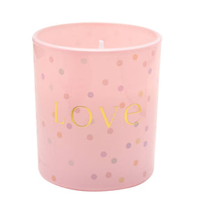 Pink cylindrical scented candle with gold "Love" text and multicolored confetti dot pattern design, 120g Celebrations Confetti candle with white wick visible