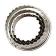 Six stainless steel crinkle cutters with wavy edges in graduated sizes arranged in nested formation on white background