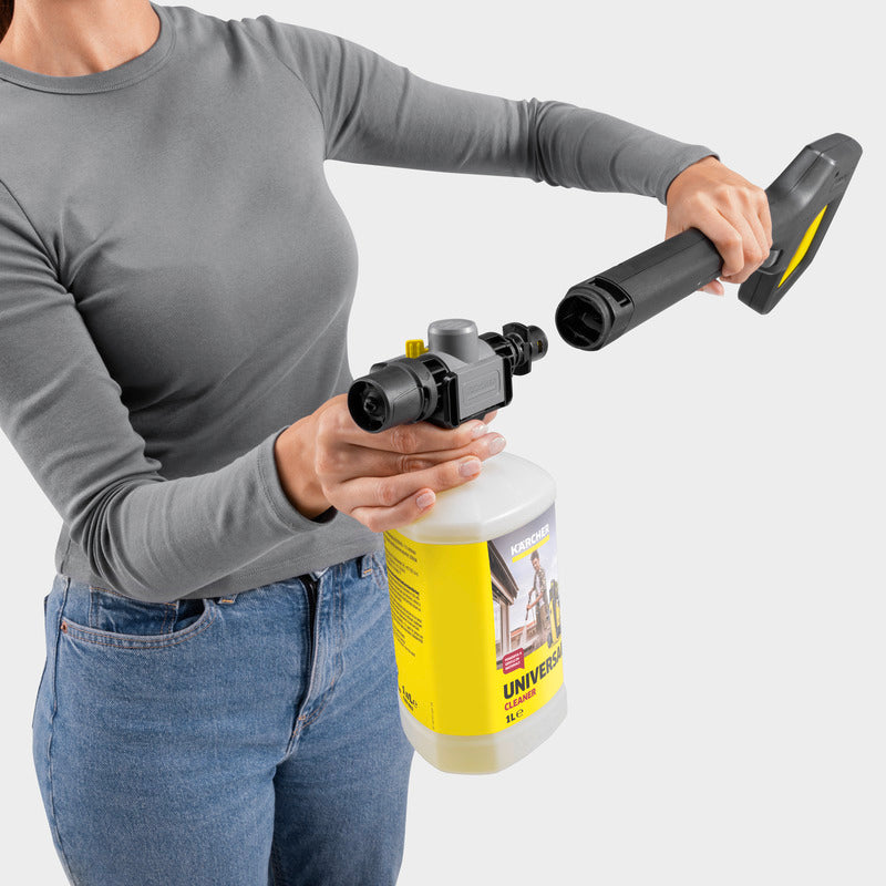 Person holding a pressure washer with a nozzle attachment on a white background