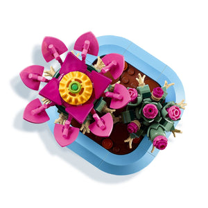 LEGO Flowering Cactus 11509 set featuring bright pink blooms with yellow center, green stems, tan leaves, and blue pot displayed from above against white background