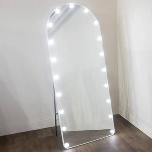 Tara Lane LED Bulb Modena Cheval Arch Mirror 160cm x 50cm in white with illuminated light bulbs around the arched frame, leaning against a white wall on dark wooden flooring