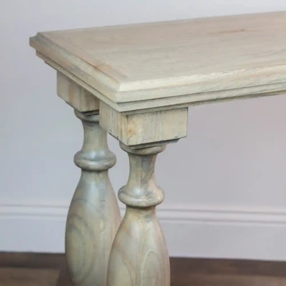 Whitewashed wooden console table with turned pedestal legs, featuring a natural wood top and classical column-style supports in a coastal farmhouse design