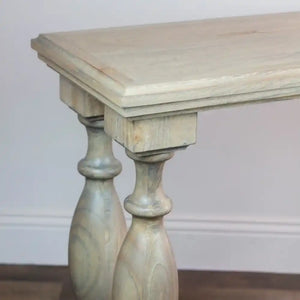 Whitewashed wooden console table with turned pedestal legs, featuring a natural wood top and classical column-style supports in a coastal farmhouse design