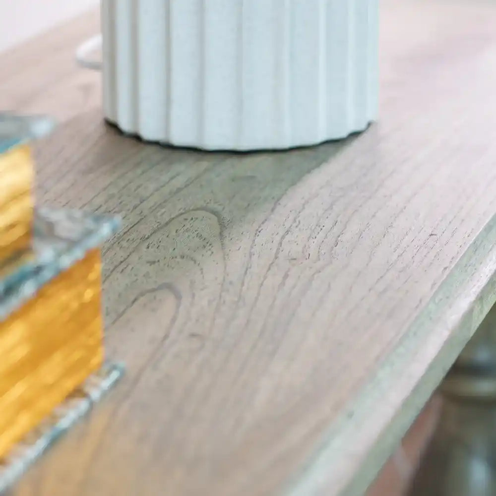 Close-up detail of Tara Lane Pillars Console Table showing light wood grain texture with white fluted pillar base and yellow measuring tape