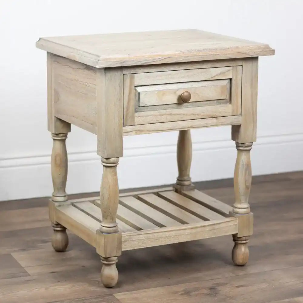 Tara Lane 1 Drawer End Table in whitewashed wood with turned legs, single drawer with bronze knob, and slatted lower shelf on hardwood floor