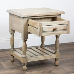 Tara Lane 1 Drawer End Table in whitewashed wood with turned legs, single drawer with bronze knob, open lower shelf, and top surface, displayed on dark wooden flooring