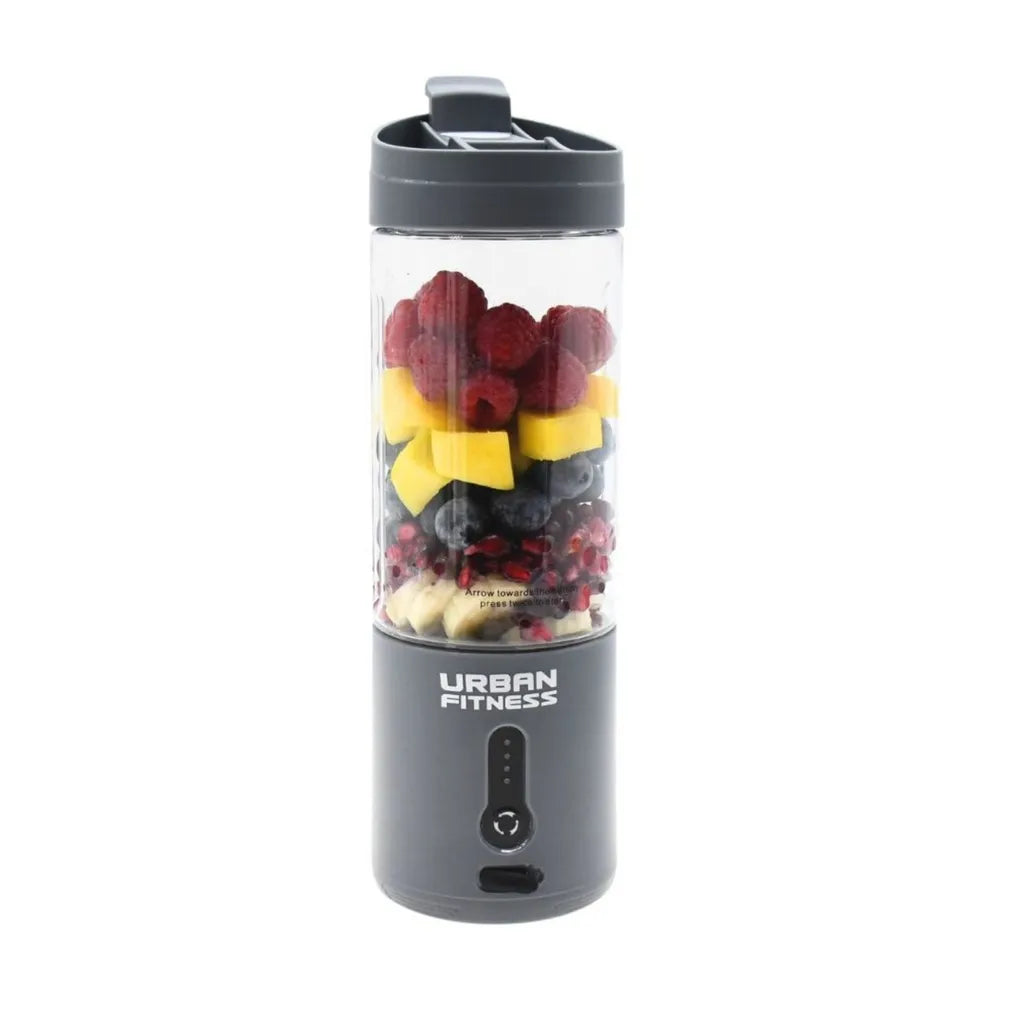 Urban Fitness VitalFuse portable blender in grey with dark berries, yellow bow decoration, and white base ingredients visible in the transparent blending chamber, featuring a dark grey base with control buttons and carry handle