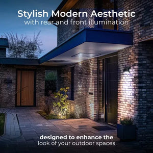 Modern brick house exterior at dusk featuring a sleek blue-topped canopy with integrated LED lighting illuminating the cream and red brick walls, dark wooden door, and landscaped garden area demonstrating contemporary outdoor lighting design