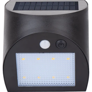 Luceco Prysm black outdoor solar LED wall light with PIR motion sensor, featuring rectangular frosted diffuser with eight amber LED lights, power button and motion sensor indicator, mounted on cylindrical dark grey body with solar panel on top