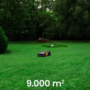 Robotic lawn mower on a green lawn with trees in the background, indicating coverage of 9,000 square meters.