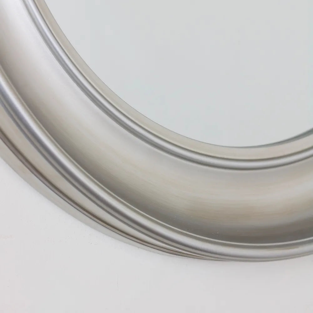Close-up detail of Tara Lane Lyla Round Mirror 90cm in champagne finish showing curved beveled edge and metallic frame against white background
