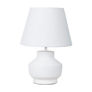 White ceramic table lamp with rounded bulbous base and tapered linen shade, modern minimalist bedside lighting design