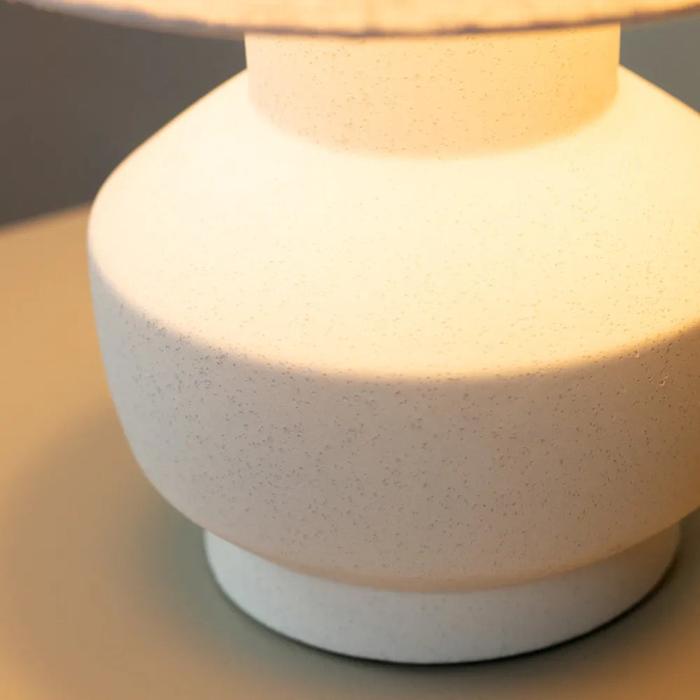 Tara Lane Chloe white ceramic bedside lamp with textured speckled finish, cylindrical dome shade, glowing warm light, 36cm height