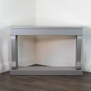 Tara Lane Scroll Console Table 120cm with mink grey finish, antique mirror top and curved silver metal supports displayed in corner setting on dark wood flooring