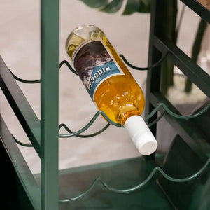 Green metal Vespa scooter-shaped wine rack holding a bottle of beer with white bottle holder, displayed against a white wall background