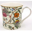Ceramic mug featuring William Kilburn botanical design with colorful hand-painted flowers including pink peonies and orange blooms, delicate blue birds, green foliage and branches on cream background, gold-trimmed rim, white interior, porcelain with curved handle