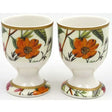 Pair of cream porcelain eggcups with gold trim featuring William Kilburn botanical design with orange flowers, green leaves and branches on pedestal base
