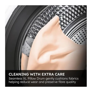 Close-up view of a Haier washing machine drum interior showing the seamless XL pillow drum design with textured metal surface and perforated holes, demonstrating gentle fabric care technology with a hand touching the soft drum surface against a dark background